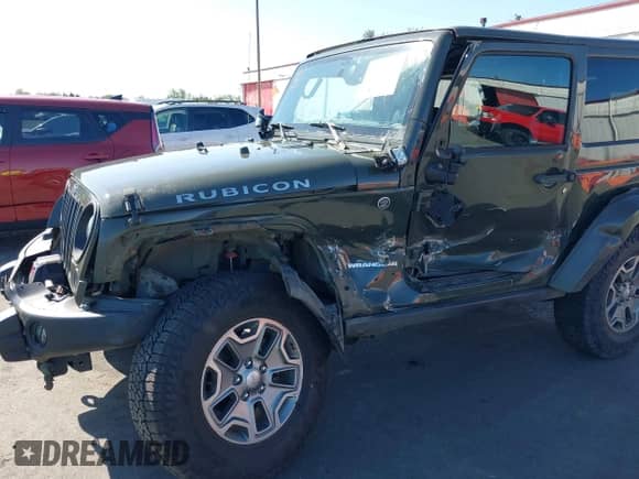 2015 Jeep Wrangler Rubicon Hard Rock z VIN 1C4BJWCGXFL771669, wystawiony jako IAAI lot #42057423 z przebiegiem 36 996 mil mil oraz . Historia ofert i sprzedaży dostępna na DreamBid. Obrazek 6.