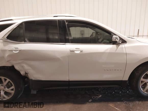 2018 Chevrolet Equinox Premier z VIN 2GNAXVEV6J6303124, wystawiony jako IAAI lot #43150684 z przebiegiem 91 946 mil mil oraz . Historia ofert i sprzedaży dostępna na DreamBid. Obrazek 14.