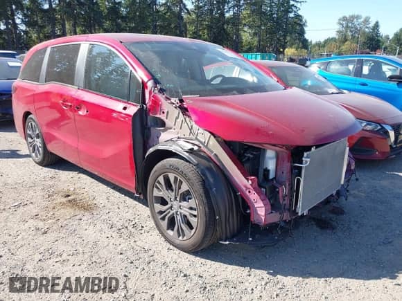 2025 Honda Odyssey Touring z VIN 5FNRL6H8XSB040537, wystawiony jako IAAI lot #43256933 z przebiegiem 4 944 mil mil oraz . Historia ofert i sprzedaży dostępna na DreamBid. Obrazek 1.