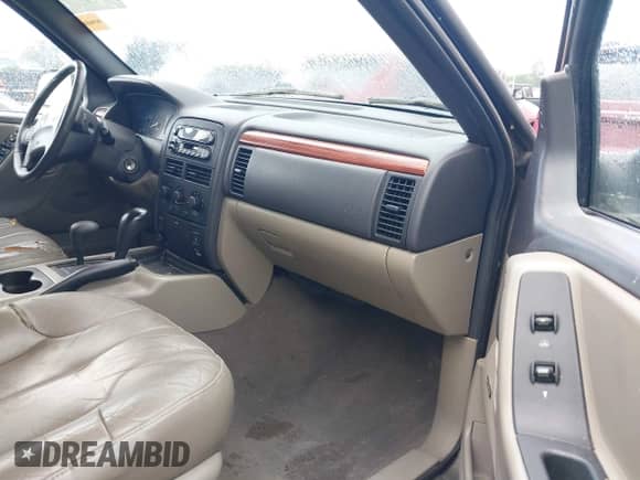 1999 Jeep Grand Cherokee Laredo z VIN 1J4GW58NXXC736618, wystawiony jako IAAI lot #43042986 z przebiegiem Nie podano mil oraz . Historia ofert i sprzedaży dostępna na DreamBid. Obrazek 5.
