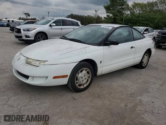 1997 Saturn SC with VIN 1G8ZF1282VZ133256, listed as a Copart auction lot 74026354 with 84,564 mi miles and Salvage title. Bid and sale history available at DreamBid. Image 1.