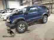 2001 Chevrolet Blazer LS z VIN 1GNCT18W01K143093, wystawiony jako Copart lot #82650514 z przebiegiem Nie podano mil oraz Szkoda całkowita • Salvage title. Historia ofert i sprzedaży dostępna na DreamBid. Obrazek 1.