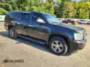 2011 Chevrolet Suburban LS with VIN 1GNSKHE37BR244285, listed as a Copart auction lot 84466945 with 161,342 mi miles and Salvage title. Bid and sale history available at DreamBid. Image 4.