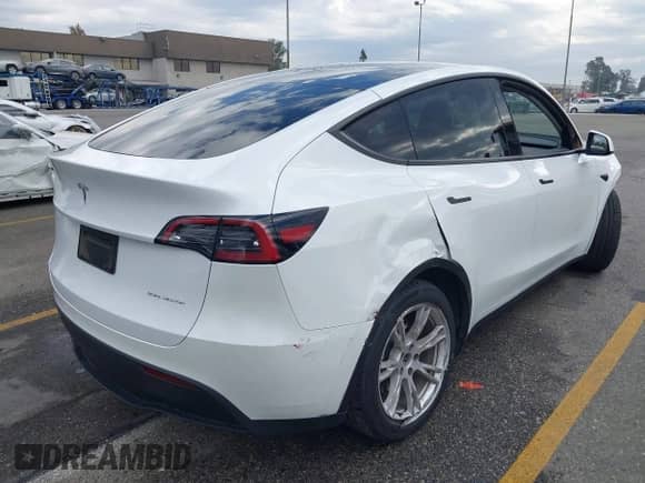 2023 Tesla Model Y Long Range with VIN 7SAYGAEE2PF763662, listed as a IAAI auction lot 43412618 with 43,857 mi miles and . Bid and sale history available at DreamBid. Image 4.