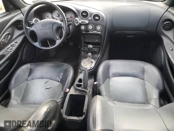2001 Hyundai Tiburon с VIN KMHJG35F01U231789, выставлен на аукционе Copart как лот 88988265 с пробегом 106 946 миль миль и Чистый • Clean title. История ставок и продаж доступна на DreamBid. Изображение 8.
