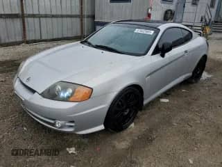 2003 Hyundai Tiburon GT с VIN KMHHN65F03U079618, выставлен на аукционе Copart как лот 47642965 с пробегом 87 483 миль миль и Чистый • Clean title. История ставок и продаж доступна на DreamBid. Изображение 1.