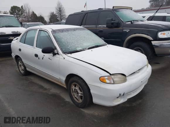 1999 Hyundai Accent GL z VIN KMHVF24N1XU583604, wystawiony jako IAAI lot #41613240 z przebiegiem 163 938 mil mil oraz . Historia ofert i sprzedaży dostępna na DreamBid. Obrazek 1.