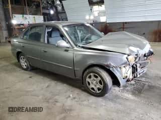 2005 Hyundai Accent GLS with VIN KMHCG45C95U632932, listed as a Copart auction lot 69448004 with Not provided miles and Salvage title. Bid and sale history available at DreamBid. Image 4.