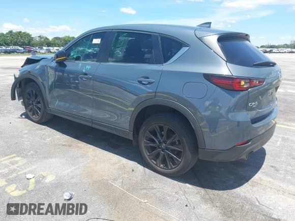 2023 Mazda CX-5 S Carbon Edition z VIN JM3KFBCM2P0200445, wystawiony jako IAAI lot #42745392 z przebiegiem 21 932 mil mil oraz . Historia ofert i sprzedaży dostępna na DreamBid. Obrazek 3.