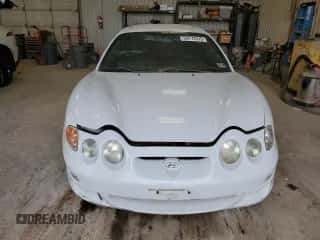 2000 Hyundai Tiburon с VIN KMHJG25F1YU217419, выставлен на аукционе Copart как лот 54772515 с пробегом 155 023 миль миль и Списание • Salvage title. История ставок и продаж доступна на DreamBid. Изображение 5.