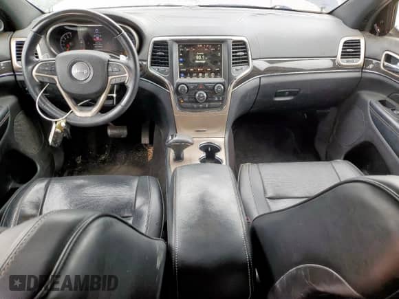 2015 Jeep Grand Cherokee Overland with VIN 1C4RJFCG7FC229492, listed as a Copart auction lot 82439445 with 104,257 mi miles and Salvage title. Bid and sale history available at DreamBid. Image 8.