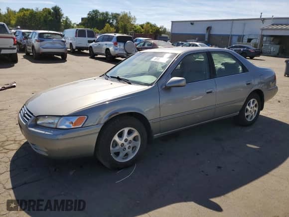1999 Toyota Camry LE with VIN JT2BF28K7X0198085, listed as a Copart auction lot 81803205 with 70,214 mi miles and Salvage title. Bid and sale history available at DreamBid. Image 1.