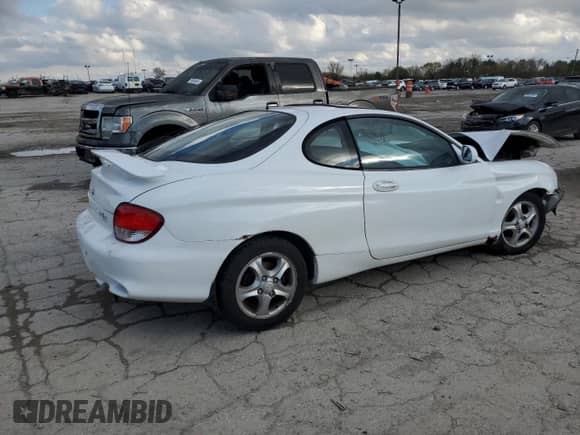 2000 Hyundai Tiburon с VIN KMHJG35F9YU191917, выставлен на аукционе Copart как лот 79629394 с пробегом 179 948 миль миль и Списание • Salvage title. История ставок и продаж доступна на DreamBid. Изображение 3.