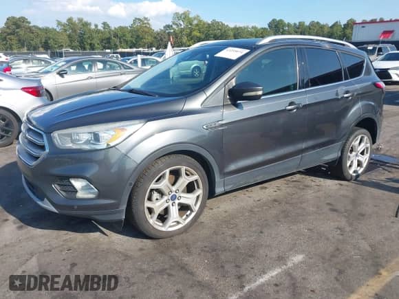 2017 Ford Escape Titanium with VIN 1FMCU0J92HUE56774, listed as a IAAI auction lot 43255074 with 107,556 mi miles and . Bid and sale history available at DreamBid. Image 2.