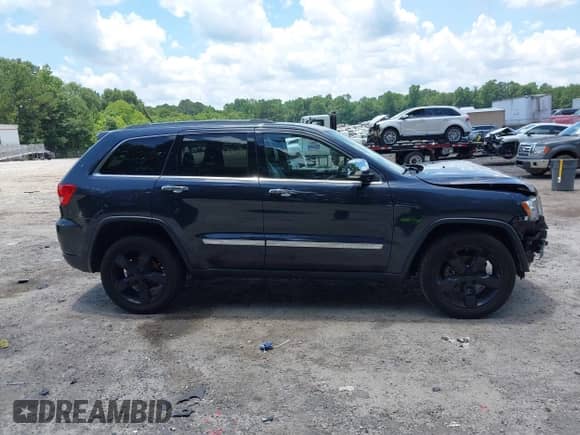 2012 Jeep Grand Cherokee Overland z VIN 1C4RJECT0CC209880, wystawiony jako IAAI lot #42533003 z przebiegiem 89 980 mil mil oraz . Historia ofert i sprzedaży dostępna na DreamBid. Obrazek 14.
