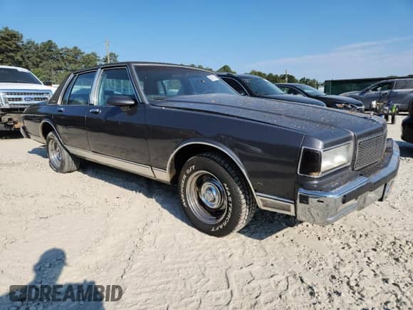 1985 Chevrolet Caprice с VIN 1G1BN69H6FY135833, выставлен на аукционе Copart как лот 80281155 с пробегом 2 381 миль миль и Списание • Salvage title. История ставок и продаж доступна на DreamBid. Изображение 4.