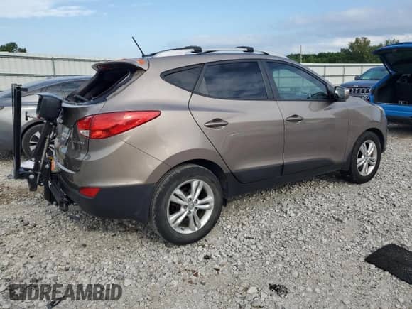 2013 Hyundai Tucson GLS with VIN KM8JU3AC2DU657332, listed as a Copart auction lot 66477995 with 148,215 mi miles and Salvage title. Bid and sale history available at DreamBid. Image 3.