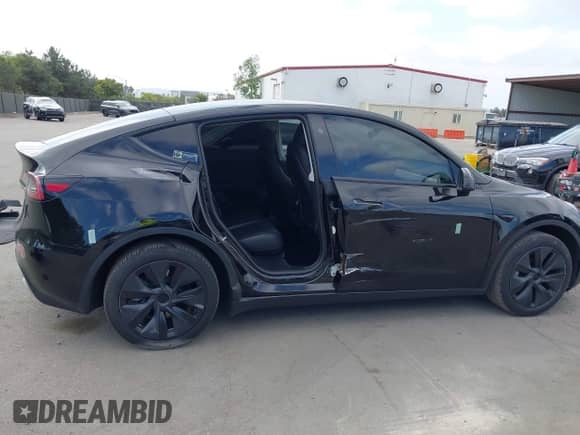 2024 Tesla Model Y with VIN 7SAYGDED8RF156984, listed as a IAAI auction lot 43324819 with 26,941 mi miles and . Bid and sale history available at DreamBid. Image 6.