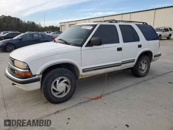 1999 Chevrolet Blazer LT z VIN 1GNDT13W1X2163194, wystawiony jako Copart lot #82897414 z przebiegiem Nie podano mil oraz Szkoda całkowita • Salvage title. Historia ofert i sprzedaży dostępna na DreamBid. Obrazek 1.