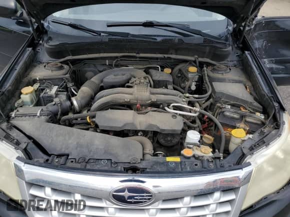 2013 Subaru Forester X z VIN JF2SHABC9DG403830, wystawiony jako Copart lot #66901685 z przebiegiem 183 552 mil mil oraz Szkoda całkowita • Salvage title. Historia ofert i sprzedaży dostępna na DreamBid. Obrazek 11.