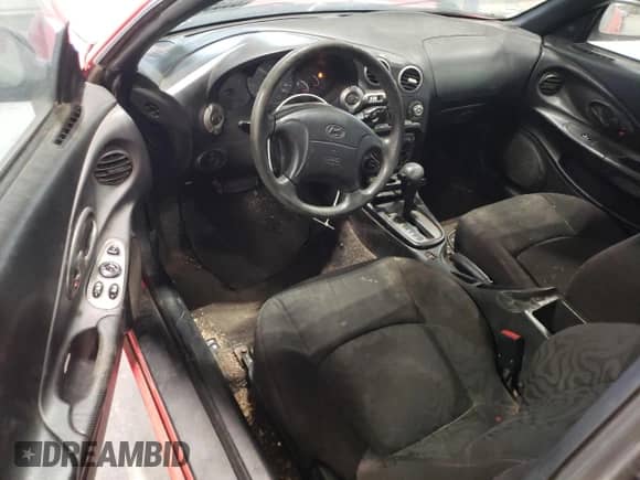 2001 Hyundai Tiburon с VIN KMHJG25F01U226912, выставлен на аукционе Copart как лот 89357135 с пробегом 131 487 миль миль и Чистый • Clean title. История ставок и продаж доступна на DreamBid. Изображение 8.