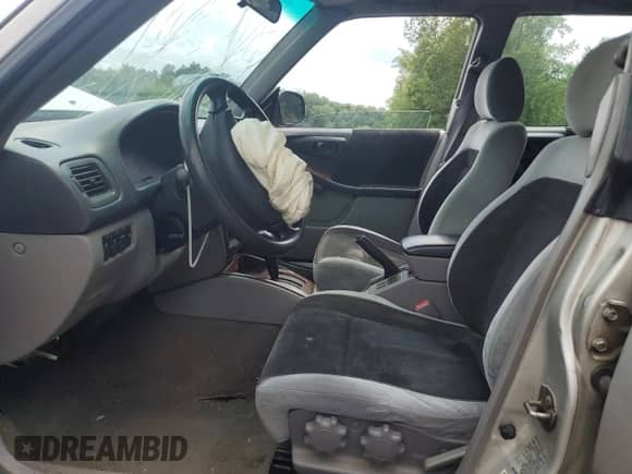 1999 Subaru Forester S with VIN JF1SF6557XH730701, listed as a Copart auction lot 65169235 with 142,246 mi miles and Salvage title. Bid and sale history available at DreamBid. Image 7.