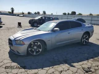 2013 Dodge Charger RT with VIN 2C3CDXCTXDH713851, listed as a Copart auction lot 64142055 with 104,984 mi miles and Salvage title. Bid and sale history available at DreamBid. Image 1.