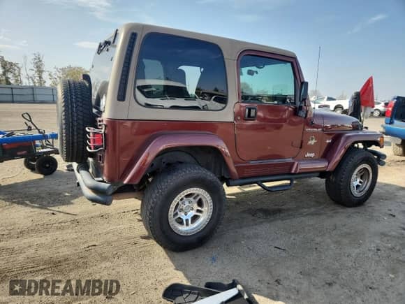 2002 Jeep Wrangler Sahara z VIN 1J4FA59S62P706936, wystawiony jako Copart lot #86420315 z przebiegiem 117 025 mil mil oraz Szkoda całkowita • Salvage title. Historia ofert i sprzedaży dostępna na DreamBid. Obrazek 3.