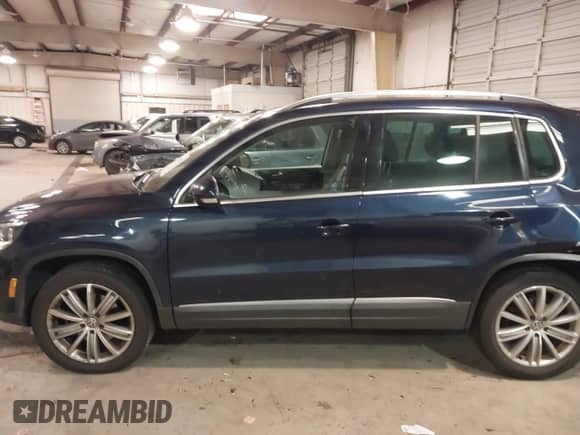 2014 Volkswagen Tiguan SEL with VIN WVGAV3AX8EW563008, listed as a IAAI auction lot 41356523 with 138,211 mi miles and . Bid and sale history available at DreamBid. Image 14.