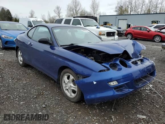 2001 Hyundai Tiburon с VIN KMHJG25F91U250108, выставлен на аукционе Copart как лот 50905795 с пробегом 61 803 миль миль и Списание • Salvage title. История ставок и продаж доступна на DreamBid. Изображение 4.