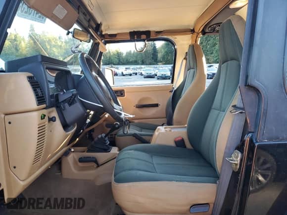 1997 Jeep Wrangler Sahara with VIN 1J4FY49SXVP486730, listed as a Copart auction lot 82473255 with 143,015 mi miles and Salvage title. Bid and sale history available at DreamBid. Image 7.