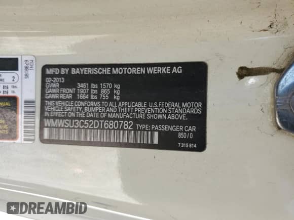 2013 MINI Hardtop with VIN WMWSU3C52DT680782, listed as a Copart auction lot 61779515 with 94,378 mi miles and Salvage title. Bid and sale history available at DreamBid. Image 12.