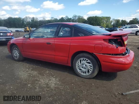1999 Saturn SC with VIN 1G8ZP128XXZ252270, listed as a Copart auction lot 81371645 with 76,945 mi miles and Salvage title. Bid and sale history available at DreamBid. Image 2.