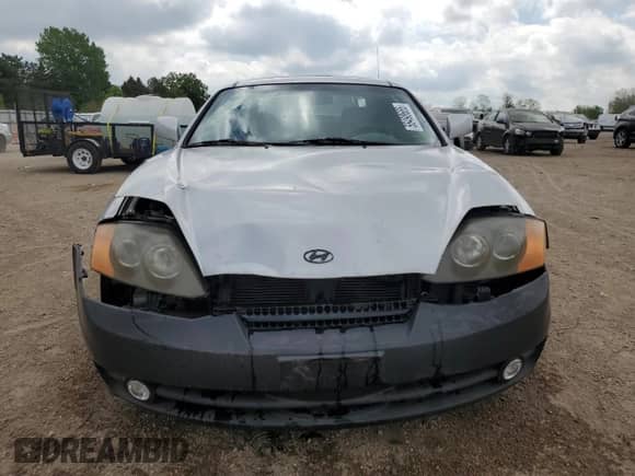 2003 Hyundai Tiburon with VIN KMHHM65D43U017995, listed as a Copart auction lot 56498665 with 162,820 mi miles and Salvage title. Bid and sale history available at DreamBid. Image 5.