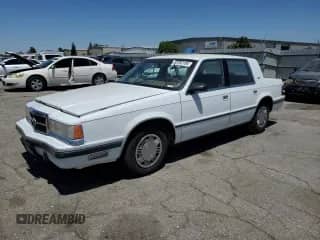 1989 Dodge Dynasty with VIN 1B3BC463XKD594439, listed as a Copart auction lot 65792195 with 61,970 mi miles and Clean title. Bid and sale history available at DreamBid. Image 1.