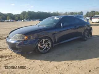 2005 Hyundai Tiburon GT с VIN KMHHN65F85U158764, выставлен на аукционе Copart как лот 80060884 с пробегом 121 747 миль миль и Чистый • Clean title. История ставок и продаж доступна на DreamBid. Изображение 1.