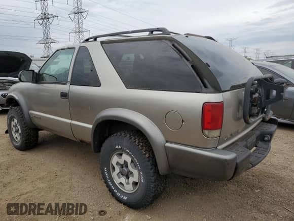 2001 Chevrolet Blazer LS z VIN 1GNCT18W61K185977, wystawiony jako Copart lot #57461385 z przebiegiem 114 357 mil mil oraz Szkoda całkowita • Salvage title. Historia ofert i sprzedaży dostępna na DreamBid. Obrazek 2.