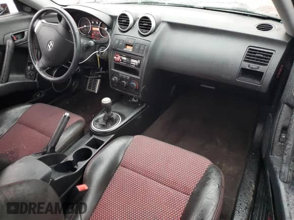 2005 Hyundai Tiburon SE с VIN KMHHN65D75U159404, выставлен на аукционе Copart как лот 83964364 с пробегом 151 777 миль миль и Списание • Salvage title. История ставок и продаж доступна на DreamBid. Изображение 8.