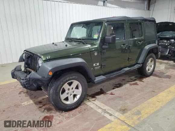 2008 Jeep Wrangler Unlimited X with VIN 1J4GA39158L583789, listed as a Copart auction lot 86292065 with 170,334 mi miles and Salvage title. Bid and sale history available at DreamBid. Image 1.