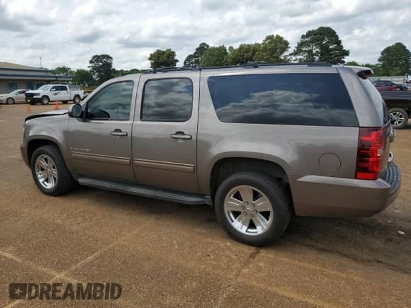 2013 Chevrolet Suburban LS with VIN 1GNSCHE00DR221307, listed as a Copart auction lot 54684925 with 203,169 mi miles and Salvage title. Bid and sale history available at DreamBid. Image 2.