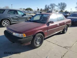 1990 Toyota Camry with VIN JT2SV21E7L3411990, listed as a Copart auction lot 88557555 with 335,803 mi miles and Salvage title. Bid and sale history available at DreamBid. Image 1.