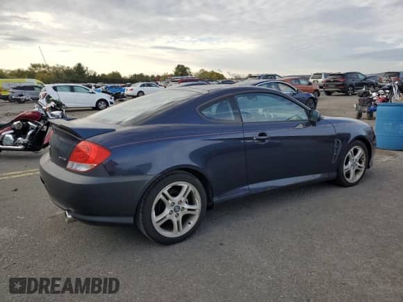 2005 Hyundai Tiburon GT с VIN KMHHN65F95U159244, выставлен на аукционе Copart как лот 76318134 с пробегом 78 324 миль миль и Чистый • Clean title. История ставок и продаж доступна на DreamBid. Изображение 3.