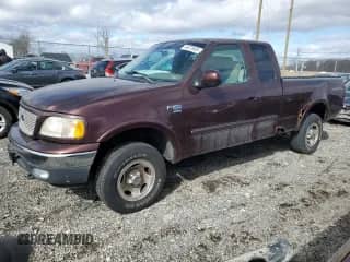 2000 Ford F-150 XL with VIN 1FTRX18WXYNB79888, listed as a Copart auction lot 46323685 with 143,904 mi miles and Salvage title. Bid and sale history available at DreamBid. Image 1.