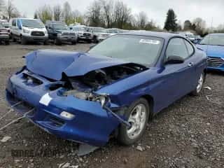 2001 Hyundai Tiburon z VIN KMHJG25F91U250108, wystawiony jako Copart lot #50905795 z przebiegiem 61 803 mil mil oraz Szkoda całkowita • Salvage title. Historia ofert i sprzedaży dostępna na DreamBid. Obrazek 1.