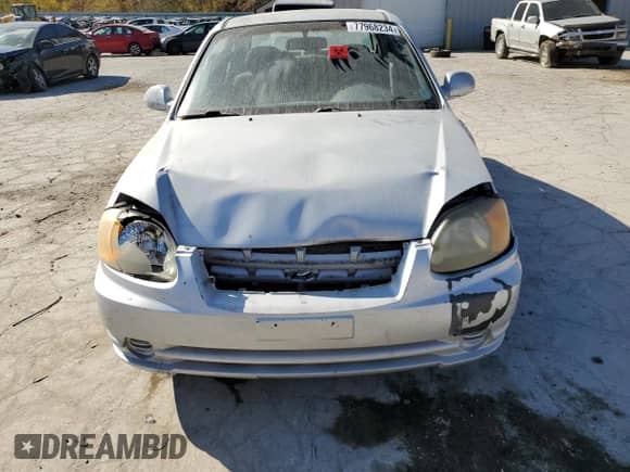 2005 Hyundai Accent GLS with VIN KMHCG45C75U638812, listed as a Copart auction lot 77968234 with 130,815 mi miles and Salvage title. Bid and sale history available at DreamBid. Image 5.