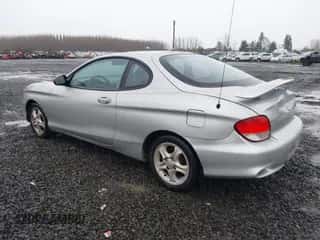 2001 Hyundai Tiburon z VIN KMHJG25F81U267658, wystawiony jako IAAI lot #41092438 z przebiegiem 188 575 mil mil oraz . Historia ofert i sprzedaży dostępna na DreamBid. Obrazek 3.