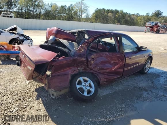 ✅ 2003 Mazda Protege DX • VIN: JM1BJ225730118870 • Lot: 81490454. Wystawiony na Copart z przebiegiem 100 026 mil. Bezpłatny archiwum sprzedaży aukcyjnych z USA i szczegółowy raport historii pojazdu na DreamBid. Zdjęcie 3.