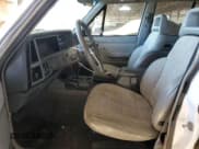 ✅ 1990 Jeep Cherokee Laredo • VIN: 1J4FJ58L8LL282842 • Lot: 87071724. Listed on Copart with 232,415 mi. Free auction sales archive from the USA and detailed vehicle history report at DreamBid. Image 7.