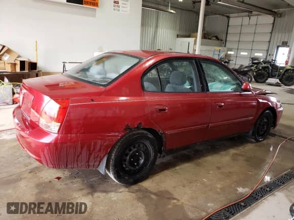 2004 Hyundai Elantra GLS z VIN KMHDN46D64U735399, wystawiony jako Copart lot #77533454 z przebiegiem Nie podano mil oraz Szkoda całkowita • Salvage title. Historia ofert i sprzedaży dostępna na DreamBid. Obrazek 3.