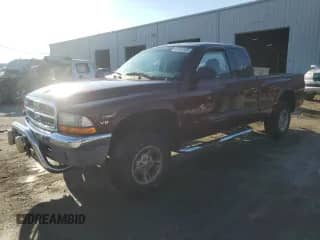 2000 Dodge Dakota Sport z VIN 1B7GG22N4YS610725, wystawiony jako Copart lot #83965225 z przebiegiem 128 401 mil mil oraz Szkoda całkowita • Salvage title. Historia ofert i sprzedaży dostępna na DreamBid. Obrazek 1.